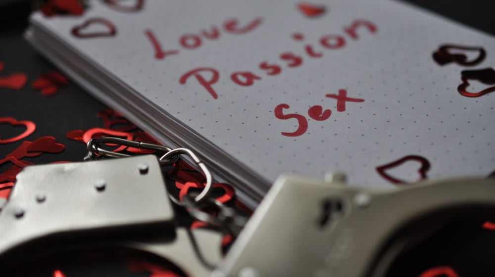 notepad with "Love, Passion, Sex" written on it